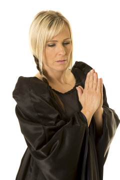 woman in black cloak hands together pray