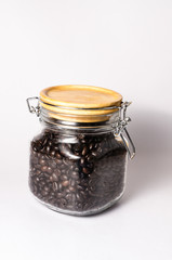 roasted coffee beans in glass bottle