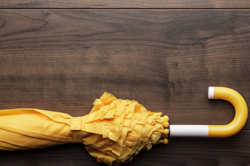 folded yellow umbrella on the table