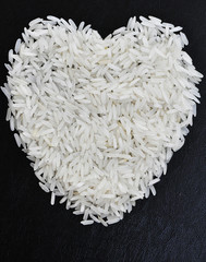 rice grains in the form of heart on a black background.