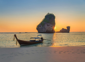 Traditional thai longtail boat at sunset Nui Bay Beach, Thailand