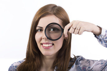 Female face looking through magnifier