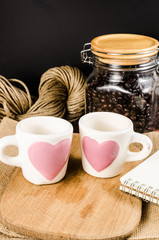 Two coffee cup on wooden board and coffee bottle with back backg