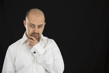 portrait of thoughtful young man isolated on black background