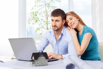 Accountancy. Young couple paying with credit card for online