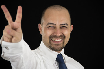 smiling business man making peace sign with his fingers