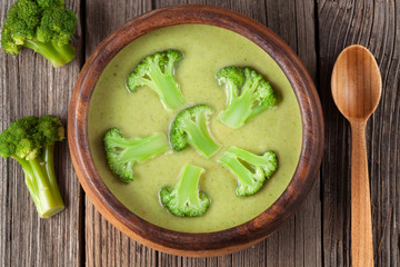 Green cream of broccoli soup vegetarian healthy dinner in bowl