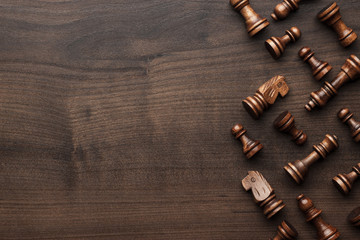 chess figures on brown wooden table background