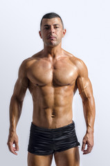 Fototapeta na wymiar Strong bodybuilder with six pac, shoulders,biceps, triceps,chest