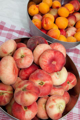 Juicy peaches and apricots  in a basket isolated
