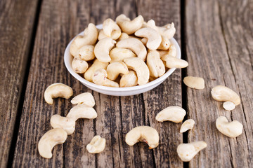 Cashews on a wooden background.