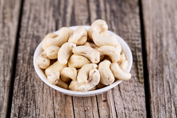 Cashews on a wooden background.