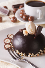 Round chocolate cake with nuts on a plate close-up,  vertical