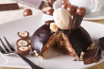 Sliced chocolate cake decorated with nuts and macaroon