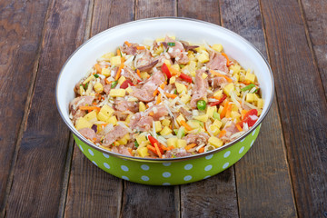 Raw meat with vegetables in a pan, stew