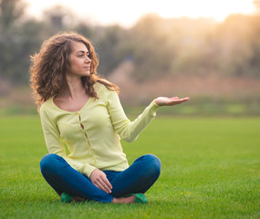 Young woman showing open hand palm with copy space for product o