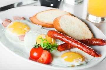 Breakfast. English breakfast with fried eggs, bacon, sausages