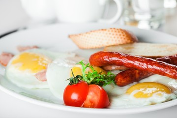 Breakfast. English breakfast with fried eggs, bacon, sausages