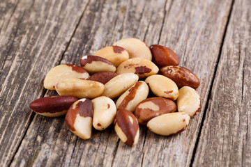 Brazil nuts on a wooden background.