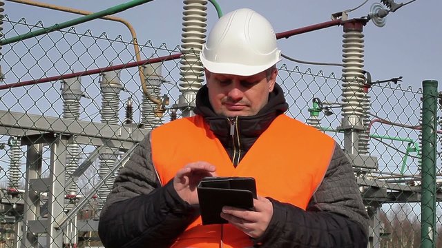 Electrical engineer  with tablet PC at power plant