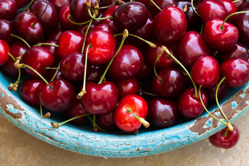 Red cherries in antique bowl