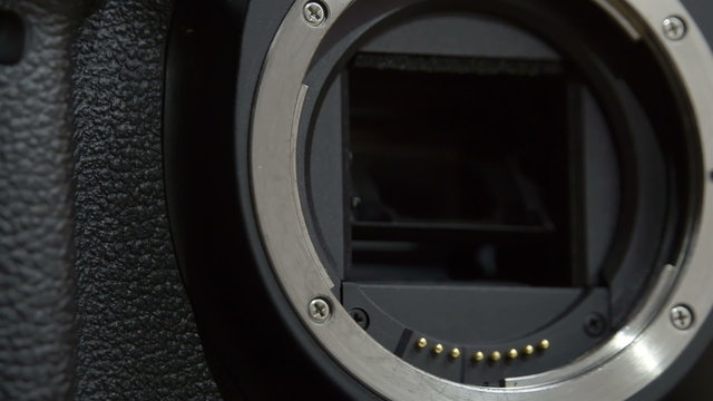 Camera lens holder where lens is attached