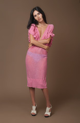 Attractive brunette woman in pink dress