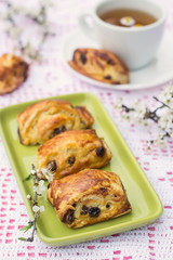 Puff pastry rolls with raisins and cream cheese
