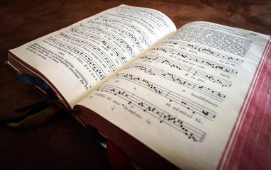 Fototapeta na wymiar Vintage psalm book with chorus singing notes
