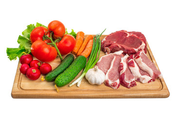 Fresh raw meat and vegetables on a cutting board