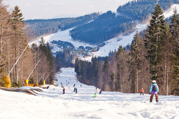 Skiers and snowboarder descends from the mountain