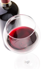 Red wine in glass with bottle