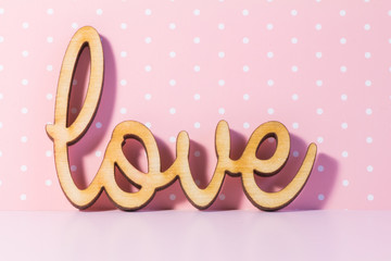 Wooden Love inscription on pink background
