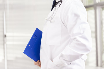 Doctor holding a clipboard at the clinic