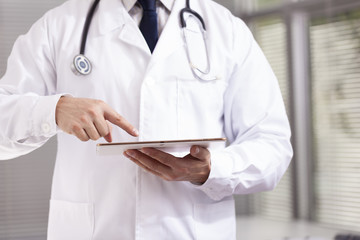 Doctor working with a digital tablet