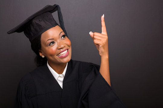 young african american graduate pointing up