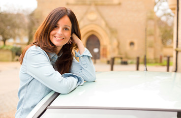 happy girl leaning out of car window.