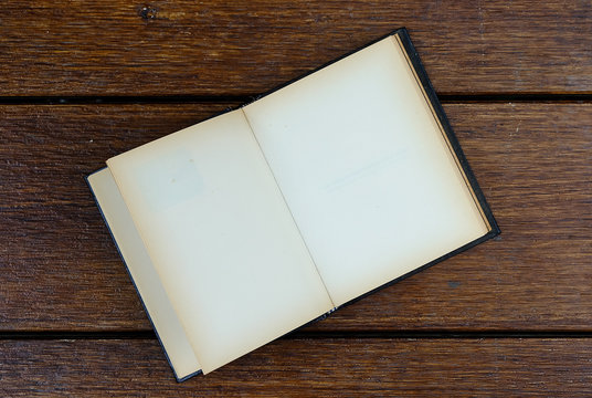 open blank old notebook on wooden table