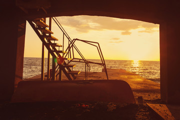 Fototapeta premium Old pier at sunset, tinted orange