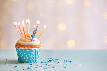 Delicious birthday cupcake on table on light background - 80362106