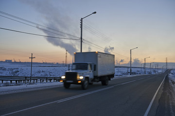 Obraz premium truck driving through landscape of coal plant in Russia