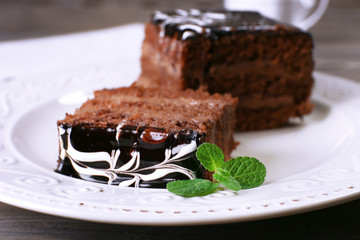 Tasty pieces of chocolate cake with mint