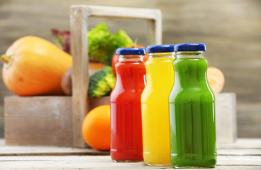 Glass bottles of fresh healthy juice with set of fruits and