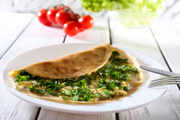 Pancakes with cream, cheese and greens in plate