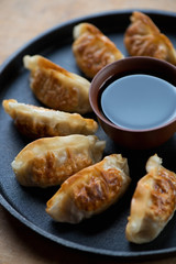 Close-up of pan fried japanese gyoza with soy sauce, studio shot