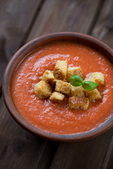 Ceramic bowl with tomato soup gazpacho, close-up, studio shot