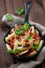Italian pasta alla Norma in a frying pan, studio shot, close-up