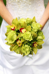 Bride Holding Bouquet Of Green Roses And Orchids