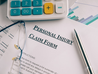 personal injury claim form on desk.