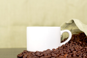 white coffee cup and coffee beans